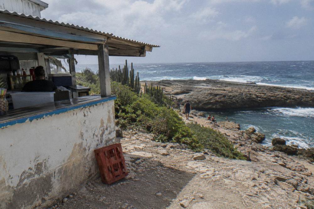 Small snack stand beside a rocky trail overlooking the sea