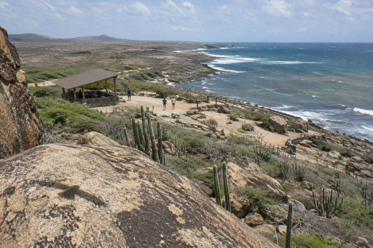 Rocky desert landscape inside Arikok National Park meeting a blue ocean on Aruba's north-east coast
