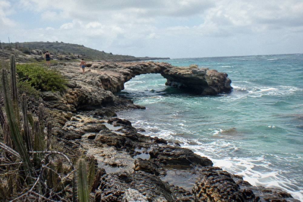 Small surviving limestone arch of the Baby Bridge over turquoise water